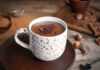 20g Hot Cocoa? Winter Trend Explodes A cup of hot chocolate topped with chocolate shavings and surrounded by hazelnuts