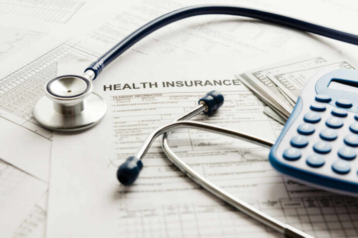 shutterstock417788401jpg Stethoscope and calculator on health insurance documents