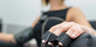 Close-up of a patients hand during a medical examination with monitoring equipment