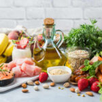 Cooking Oil’s Toxic Secret A variety of fresh foods including fruits, vegetables, and oils arranged on a table