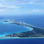Oceans More Polluted Than Imagined Aerial view of a tropical island surrounded by blue ocean waters