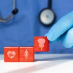 Menopause’s Hidden Cardiovascular Trap A doctor's gloved hand placing red blocks with health symbols on a table