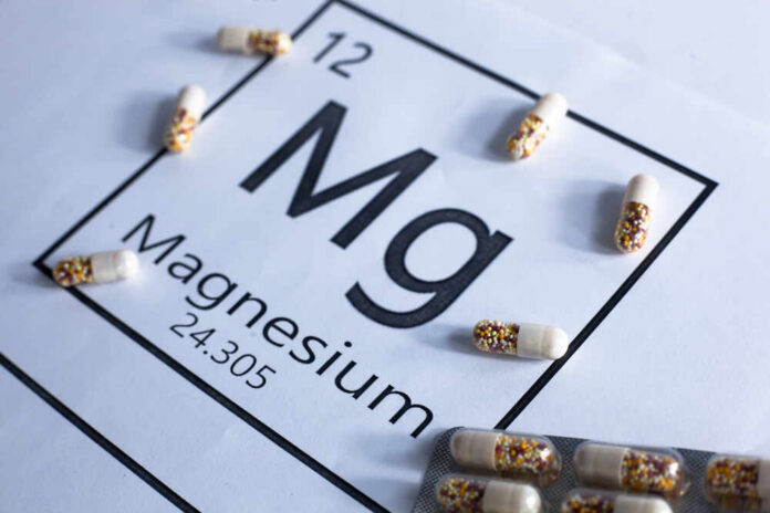 Magnesium element symbol with colorful capsules arranged around it