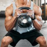 Short Sessions, Big Strength — Here’s The Catch Athlete performing a kettlebell squat in a gym