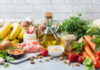 One Fruit Quietly Lowers Carb Load and Blood Sugar A variety of fresh foods including fruits, vegetables, and oils arranged on a table