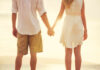 Growing trend of besties co-parenting and raising kids together Couple holding hands at the beach during sunset