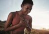 New Harvard Study Sparks Fitness Panic A woman in athletic wear holding her chest with a pained expression outdoors