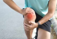 New Pinhole Fix Procedure Stuns Aching Knees Athlete holding their knee in pain while exercising outdoors