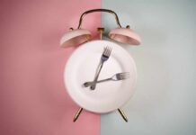 Why Fasting is not Recommended After 60 An alarm clock with a plate and two forks arranged in a creative design