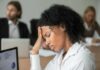 Unseen Migraine Triggers: New Findings Woman in office holding her head with eyes closed