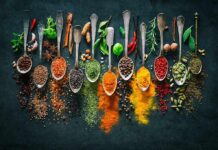 Spice Combo That Lowers Blood Sugar Assorted spices in vintage spoons on dark background