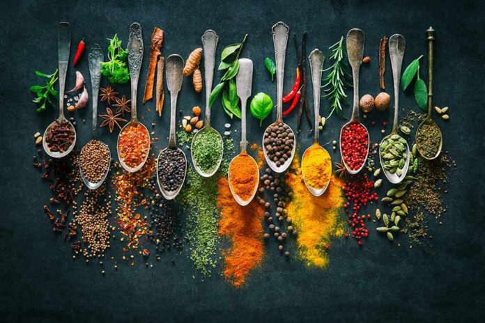 shutterstock_1060609166 Assorted spices in vintage spoons on dark background