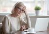 Ways to Improve Your Memory and Cognitive Function at Any Age Older woman with glasses looking concerned at laptop