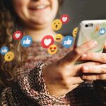 AI Companions: Comfort Or Costly Trap? Person using smartphone with social media reaction icons floating around