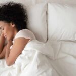 Sleep Position Triggers Three Strokes Woman sleeping on white bedding