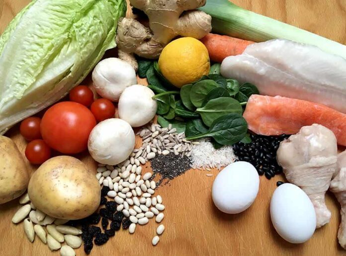shutterstock_1038213115 Assorted fresh foods including vegetables, grains, eggs, fish, and chicken