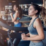 Woman running on a treadmill in a gym