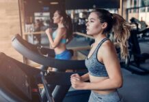 Woman running on a treadmill in a gym