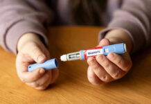 Thin But Stuck? New Ozempic Reality Check Hands holding an Ozempic injection pen.