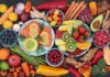 Assorted fruits, vegetables, and salmon slices on plates