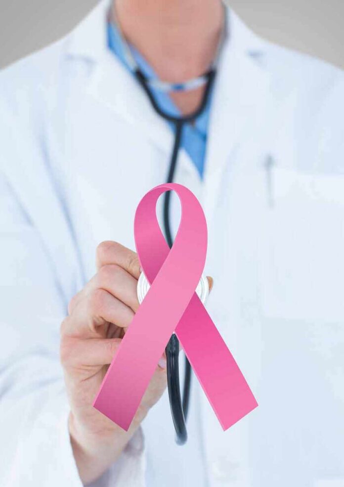 shutterstock_1087739549-1 Doctor holding stethoscope with pink ribbon in front