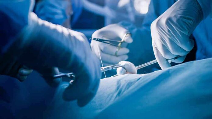 Surgeons' gloved hands performing an operation