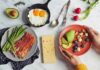 Keto Diet: Short-Term Win, Long-Term Risk? Breakfast spread with bacon, asparagus, eggs, avocado, berries, nuts, and cheese
