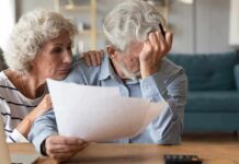 Spousal Dementia Domino Effect Older couple reviewing paperwork at home