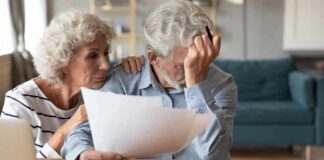 Older couple reviewing paperwork at home