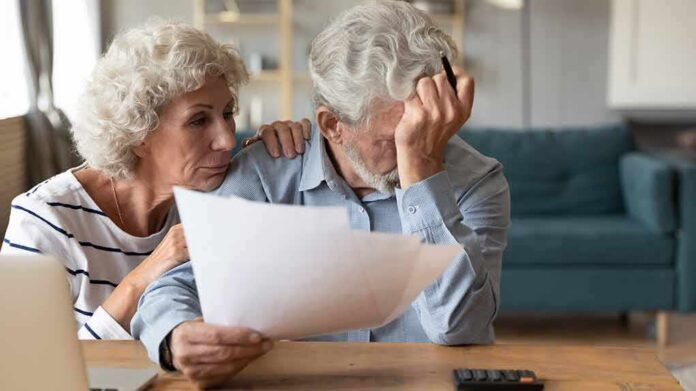 Older couple reviewing paperwork at home