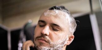 Man washing face and beard with soap