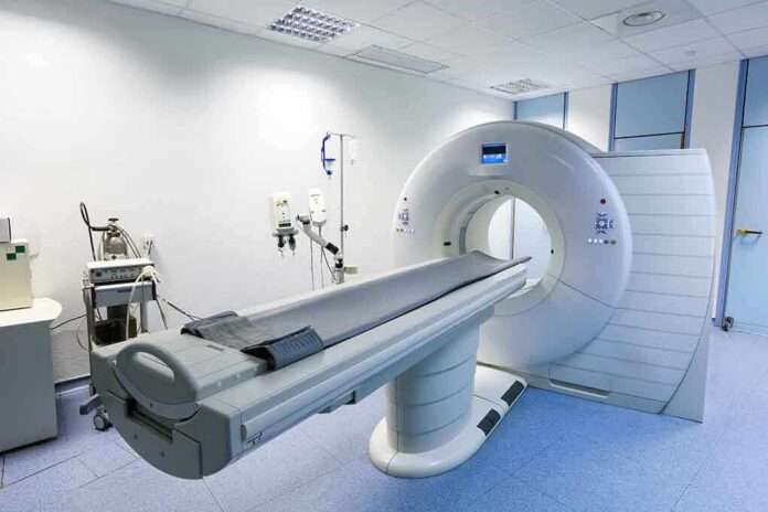 shutterstock_204885118 A CT scanner in a hospital room with medical equipment nearby