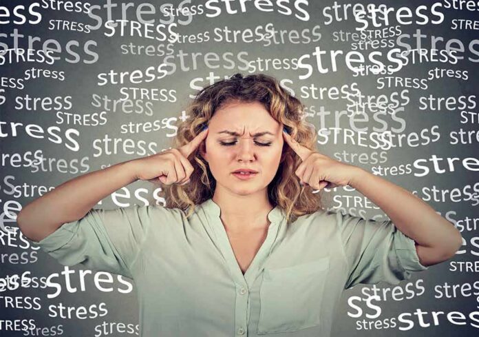 shutterstock_548638960 woman pressing fingers to temples with eyes closed