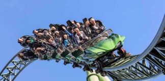roller coaster train with riders on a curved track
