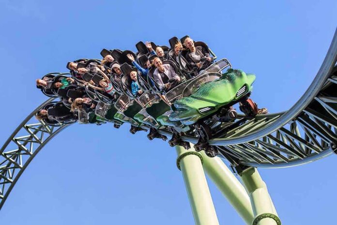 roller coaster train with riders on a curved track