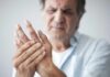 Osteoporosis Ambush: Why Men Get Hit Harder Man holding his hand in discomfort