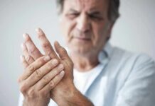 Man holding his hand in discomfort