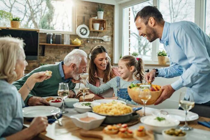 Family gathered around a dining table sharing a meal