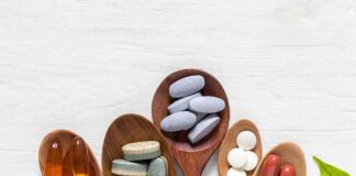 Assorted dietary supplements on wooden spoons