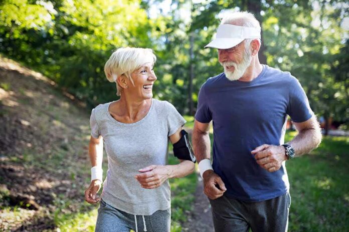 shutterstock_1330970468 older couple jogging together in a sunny park