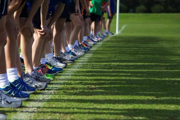 Runners lined up at a starting line on grass