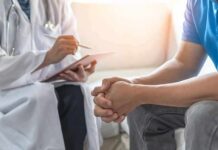 Doctor consulting a patient on a sofa