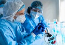 ‘Synthetic Urine’ Powers Hospital Tech Scientists in protective gear working with a syringe in a laboratory