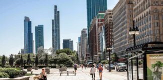 City street with pedestrians and tall modern skyscrapers