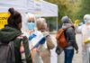 Ebola spreads into 4 new countries. A look at where things stand Healthcare workers in PPE assist people at an outdoor COVID-19 testing site