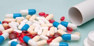Assorted pills and capsules spilled from a bottle