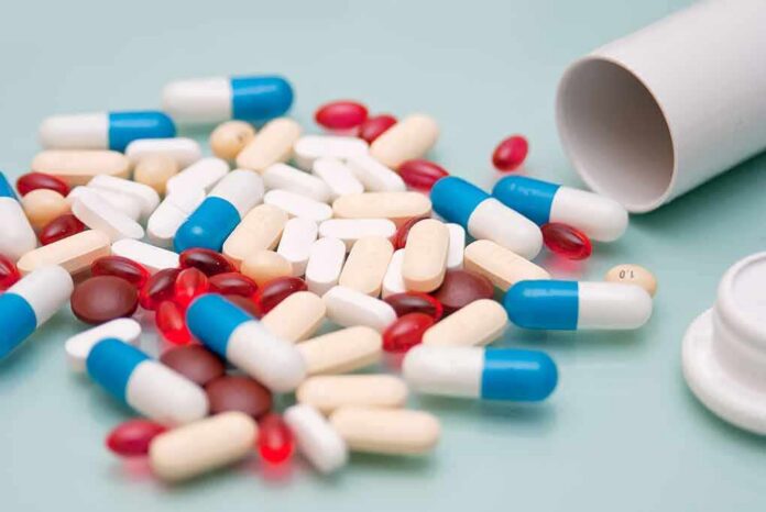 Assorted pills and capsules spilled from a bottle