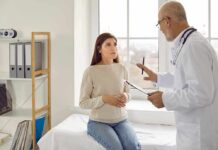When You Need To See A Cardiologist Doctor talking with patient in a clinic exam room