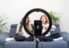smartphone on ring light filming two people on a couch