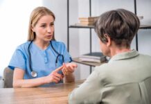 Common Symptoms ENT Doctors Say Never to Ignore Healthcare professional consulting with an older woman at a desk